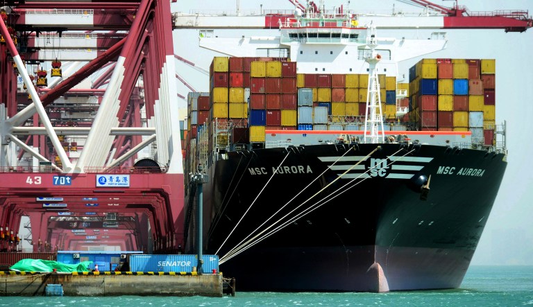 Containers are loaded onto a cargo ship in east China's Shandong province. A U.S. trade dispute with China and other protectionist policies risk damaging America's economic growth, the International Monetary Fund warned.