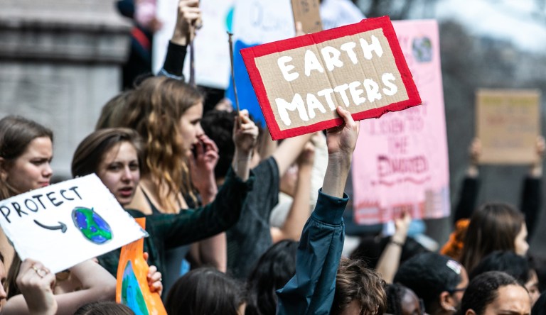 In photo taken Thursday Oct.19, 2017 Moroccan women fill up containers with water from a hose, in Zagora, southeastern Morocco. Experts blame poor choices in agriculture, growing populations and climate change for the water shortages in towns like Zagora, which has seen repeated protests for access to clean water in recent weeks. Since the summer, taps ran dry in Zagora.
