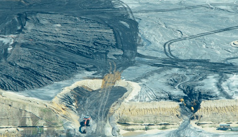 In this Sept. 19, 2018, photo released by Cape Fear River Watch, an earth mover is used to repair one of several breaches in a ruptured coal ash landfill at the L.V. Sutton Power Station in Wilmington, N.C. The landfill under construction at the site meant to hold coal ash in lined terraces ruptured over the weekend from heavy rains from Hurricane Florence, spilling enough material to fill 180 dump trucks. Coal ash contains arsenic, mercury and other toxic metals.