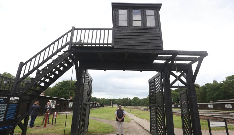 In this July 18, 2017 file photo, the wooden main gate leads into the former Nazi German Stutthof concentration camp in Sztutowo, Poland. 93-year-old former SS private Bruno Dey is going on trial at the criminal court in Hamburg on 5,230 counts of being an accessory to murder, accused of helping the Nazis' Stutthof concentration camp function. 