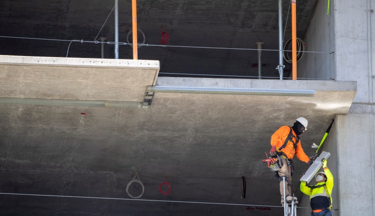 Workers work on drainage on a street in Waukegan, Ill., Monday, Nov. 6, 2023.