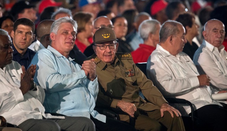 Cuba's former President Raul Castro, center, and Cuba's President Miguel Diaz-Canel, second left, attend an event celebrating Revolution Day in Santiago, Cuba, Thursday, July 26, 2018. Cuba marks the 65th anniversary of the July 26, 1953 rebel attack led by Fidel and Raul Castro on the Moncada military barracks. The attack is considered the beginning of Fidel Castro's revolution that culminated with dictator Fulgencio Batista's ouster.