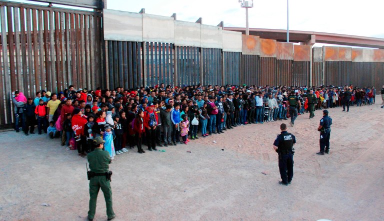 This May 29, 2019 photo released by U.S. Customs and Border Protection (CBP) shows some of 1,036 migrants who crossed the U.S.-Mexico border in El Paso, Texas, the largest that the Border Patrol says it has ever encountered.