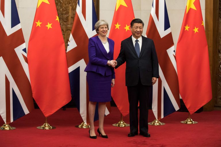 U.K. Prime Minister Theresa May hakes hands with China's President Xi Jinping ahead of their bilateral meeting at the Diaoyutai State Guest House in Beijing, China, on Feb. 1. May is leading the largest business delegation her government has ever taken overseas as she seeks to put her Brexit troubles aside and make progress on boosting U.K. trade. (Chris Ratcliffe/Bloomberg)