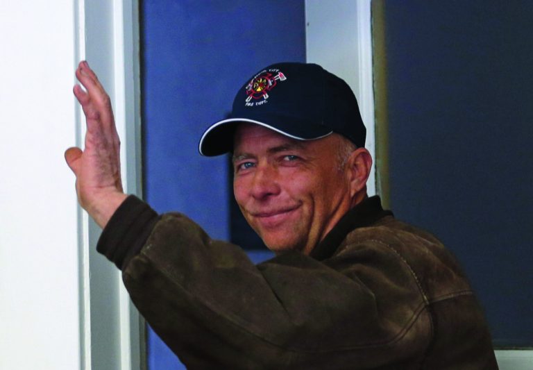 Spring City Councilman Neil Sorensen waves as he leaves the City Hall Tuesday, Jan. 8, 2013, in Spring City, Utah. Officials in a small Utah town are urging citizens and teachers to arm themselves for everyone's safety against any aggressor. One member of the Spring City council wants to make the edict mandatory, but police are urging restraint. Councilman Neil Sorensen says he's drafting a measure that will go before the full council in February. At first, Sorensen wanted to mandate a gun in every household in the town of 1,000. But the Sanpete County sheriff didn't think it was a good idea to force households to own guns, so Sorensen says he's inclined to make it a recommendation, not a law. (AP Photo/Rick Bowmer)