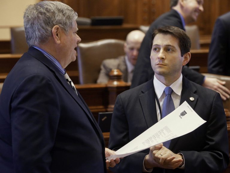 In this March 7, 2013 photo, Illinois state Sens. Jason Barickman, R-Bloomington, right, and Jim Oberweis, R-North Aurora, chat on the Senate floor at the Illinois State Capitol in Springfield. On Saturday, March 9, 2013, the Illinois Republican Party's state central committee will hold a special meeting where they are expected to fire party Chairman Pat Brady, in large part because he spoke out in favor of a bill to end Illinois' ban on gay marriage. And two county-level Republican party committees have passed resolutions against Barickman, the only Republican to vote yes for the bill in the Illinois Senate last month. (AP Photo/Seth Perlman)