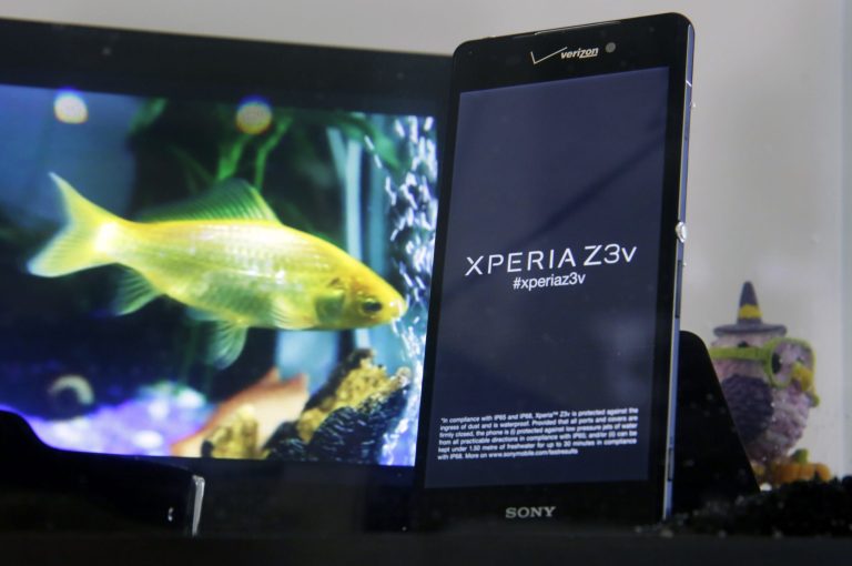 The Sony Xperia Z3v smartphone, available through Verizon, is submerged in a fish tank during a media event in New York on Thursday, Oct. 9, 2014. Both the Verizon and standard T-Mobile versions let people play Sony PlayStation 4 games through the phone while on the porch or in another room from the TV. The phones are waterproof and have 20.7 megapixel cameras. (AP Photo/Richard Drew)