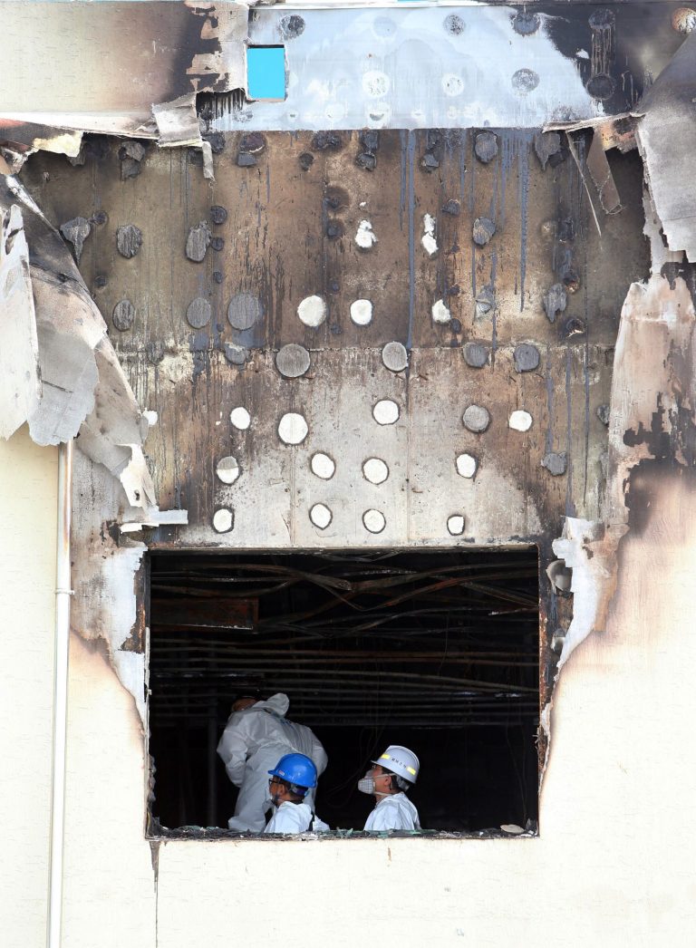 Police officers investigate in a burned out hospital in Jangseong, South Korea, Wednesday, May 28, 2014. A fire at the hospital annex housing elderly patients in the southwestern county of Jangseong killed 21 people early Wednesday, officials said. (AP Photo/Yonhap, Hyung Min-woo)  KOREA OUT