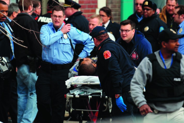 Police and emergency personal respond to a shooting victim at Stevens Institute of Business and Arts in St. Louis on Tuesday, Jan. 15, 2013. Police say a gunman entered the school and shot a person in the chest, then shot himself. Everyone inside the building was evacuated, though police were checking the school to make sure the building was empty. The conditions of the shooting victims were not immediately known. (AP Photo/St. Louis Post-Dispatch, David Carson)