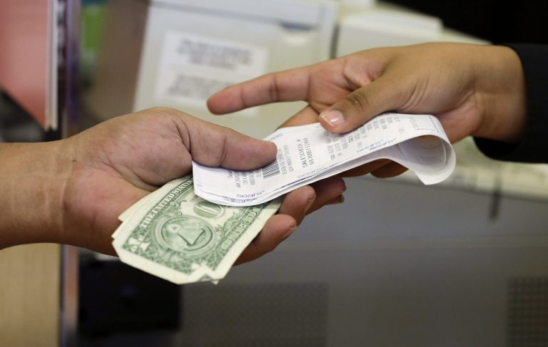   In this Friday, Nov. 23, 2012 photo, a cashier hands a customer his change and receipt during a transaction at a Sears store, in Henderson, Nev. Consumers spent and earned more in November, reflecting a rebound from the disruptions caused by Superstorm Sandy. The Commerce Department says, Friday, Dec. 21, 2012, consumer spending rose 0.4 percent compared with October. Personal income jumped 0.6 percent, the biggest gain in 11 months. (AP Photo/Julie Jacobson)  