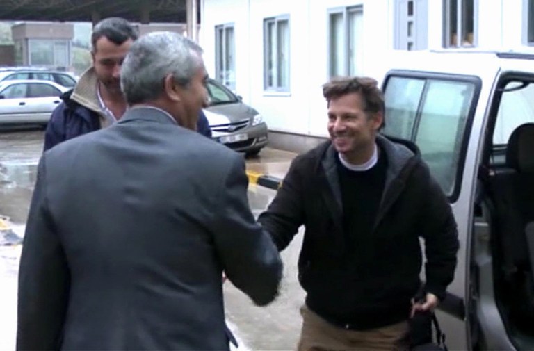   In this image made from video, NBC chief foreign correspondent Richard Engel, right, shakes hands with an unidentified person after crossing back into Turkey, after they were freed unharmed following a firefight at a checkpoint after five days of captivity inside Syria, in Cilvegozu, Turkey, Tuesday, Dec. 18, 2012. Engel told the Turkish news agency Anadolu that he and his colleagues are 