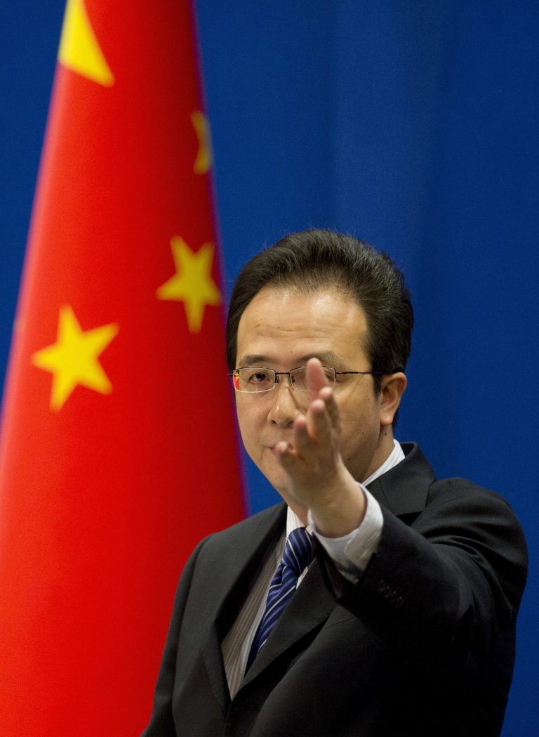 Foreign ministry spokesman Hong Lei gestures during a daily briefing at the Ministry of Foreign Affairs office in Beijing, China Tuesday, May 20, 2014. China on Tuesday warned the United States was jeopardizing military ties by charging five Chinese officers with cyberspying and tried to turn the tables on Washington by calling it 