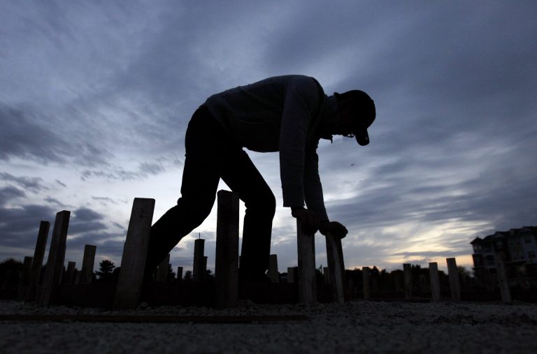 In this Thursday, Oct. 11, 2012, photo, Ford Smith works on a new home under construction in Chicago. U.S. builders increased their spending on construction projects in October by the largest amount in five months, led by a surge in housing.