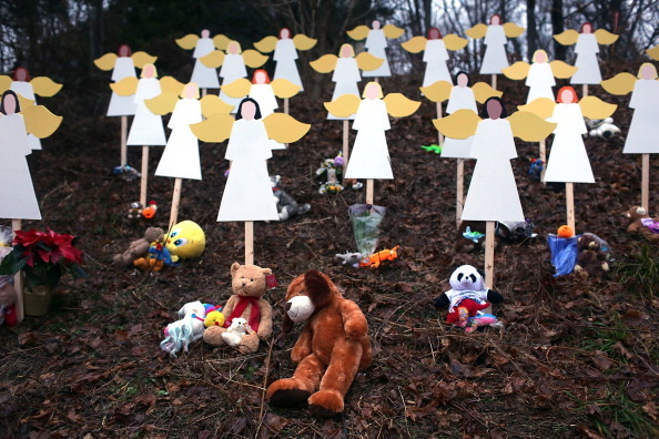 NEWTOWN, CT - DECEMBER 16:  Twenty seven wooden angels stand in a yard down the street from the Sandy Hook School December 16, 2012 in Newtown, Connecticut. Twenty-six people were shot dead, including twenty children, after a gunman identified as Adam Lanza opened fire at Sandy Hook Elementary School. Lanza also reportedly had committed suicide at the scene. A 28th person, believed to be Nancy Lanza, found dead in a house in town, was also believed to have been shot by Adam Lanza.  (Photo by Spencer Platt/Getty Images)