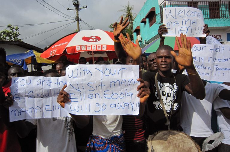 People protest outside a hospital as Liberia President Ellen Johnson Sirleaf visits the area after Ebola deaths in Monrovia, Liberia, Tuesday, June 17, 2014.  Seven people believed to have the Ebola virus have died in recent days in the first deaths reported in the Liberian capital since the outbreak began, a health official said Tuesday. (AP Photo/Jonathan Paye-Layleh)
