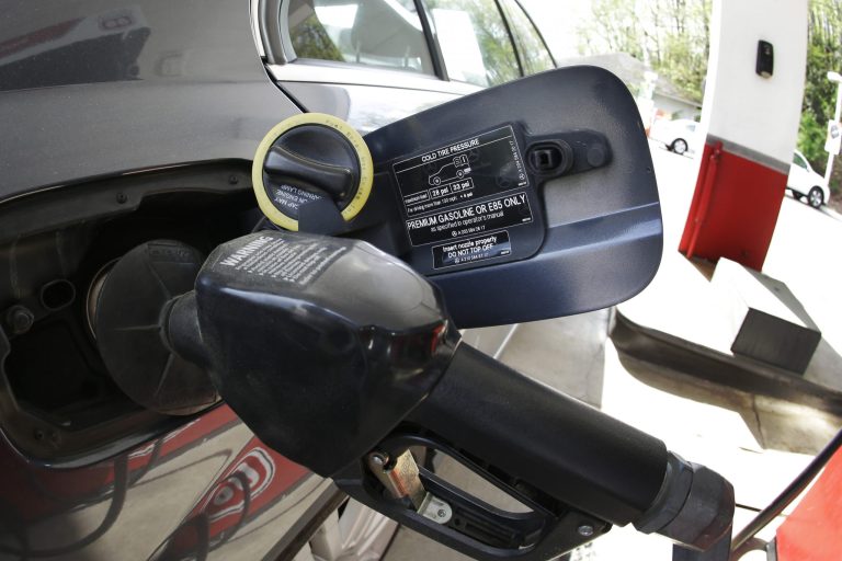 In this April 11, 2014 photo made with a fisheye lens, gasoline is pumped into an automobile at a Phillips 66 gas station in Little Rock, Ark. Lower U.S. gasoline prices kept consumer inflation in check last month, helping to offset higher costs for food and clothing. The Labor Department said Tuesday, April 15, 2014, that the consumer price index rose 0.2 percent in March, after scant 0.1 percent increases in the previous two months (AP Photo/Danny Johnston)
