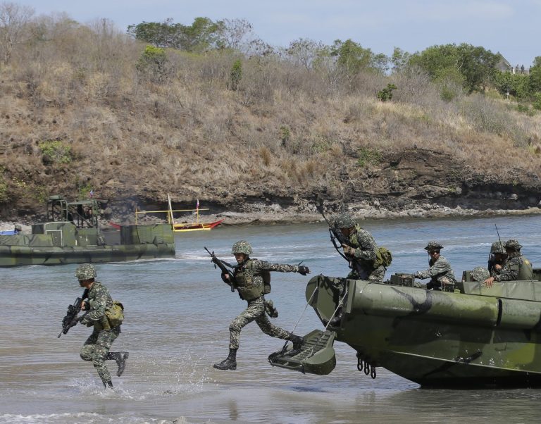 In this May 11, 2014 file photo, Philippine Marines exit from a U.S.-made fast craft as they assault a target during a live-fire joint U.S.-Philippines military exercise dubbed Balikatan 2014 at the Philippine Marine base at Ternate township, Cavite province south of Manila, Philippines. (AP Photo/Bullit Marquez, File)