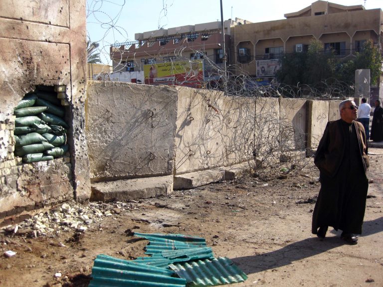 A car bombing attack left a hole in a wall of a juvenile prison in the Toubchi district of western Baghdad, Iraq, Sunday, Jan. 19, 2014. (AP Photo/Hadi Mizban)