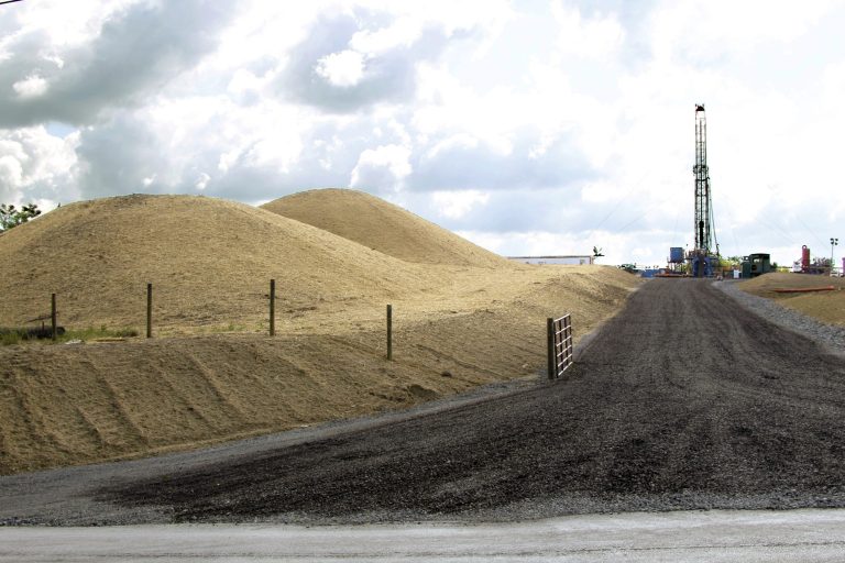 A crew works on a drilling rig at a well site for shale-based natural gas in Zelienople, Pa., in June 2012. (AP Photo/Keith Srakocic)