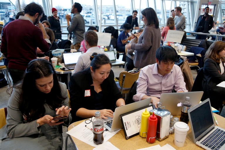Volunteer lawyers work to help free travelers detained at John F. Kennedy International Airport in New York, Sunday, Jan. 29, 2017. The rapid succession of orders under Trump has left lawyers scrambling to keep up with the changes. (AP Photo/Seth Wenig)