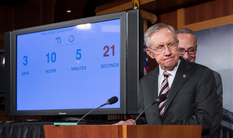 Senate Majority Leader Harry Reid of Nev., foreground, and Sen. Charles Schumer, D-N.Y. , stand next to a countdown clock indicating three days to go before the federal government is due to run out of money, Friday, Sept. 27, 2013, during a news conference on Capitol Hill in Washington, after passing a stopgap spending bill to keep the government running, but stripped of the defund "Obamacare" language, as crafted by House Republicans. (AP Photo/J. Scott Applewhite)