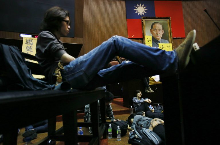 Student protesters against a China Taiwan trade agreement occupy the floor of the legislature after a night of scuffling with police in Taipei, Taiwan, Wednesday, March 19, 2014. Several hundred opponents of a far-reaching trade pact with China occupied Taiwan's legislature late Tuesday, further delaying action on a measure that Beijing strongly favors. (AP Photo/Wally Santana)
