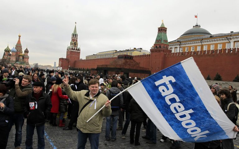 Opposition supporter waves a Facebook flag during a protest at the Red Square in Moscow\. (AP Photo/Sergey Ponomarev)