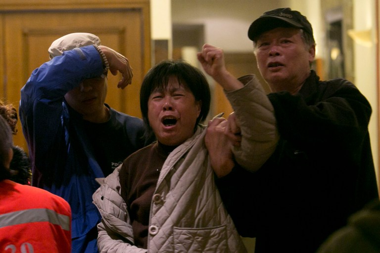 A relative of one of the Chinese passengers aboard the Malaysia Airlines, MH370 grieves after being told of the latest news in Beijing, China, Monday, March 24, 2014. A new analysis of satellite data indicates the missing Malaysia Airlines plane crashed into a remote corner of the Indian Ocean, Malaysian Prime Minister Najib Razak said Monday. Malaysia Airlines said in a statement to the families that 