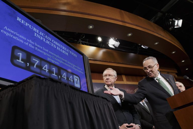 Sen. Charles Schumer, D-N.Y., the Democratic Policy Committee chairman, right, accompanied by Senate Majority Leader Harry Reid of Nev., points to a graphic during a news conference on Capitol Hill in Washington, Thursday, Feb. 6, 2014, where they told reporters that Republicans are thwarting Democratic efforts pass a bill to extend unemployment benefits which expired at the end of last year.  (AP Photo/J. Scott Applewhite)