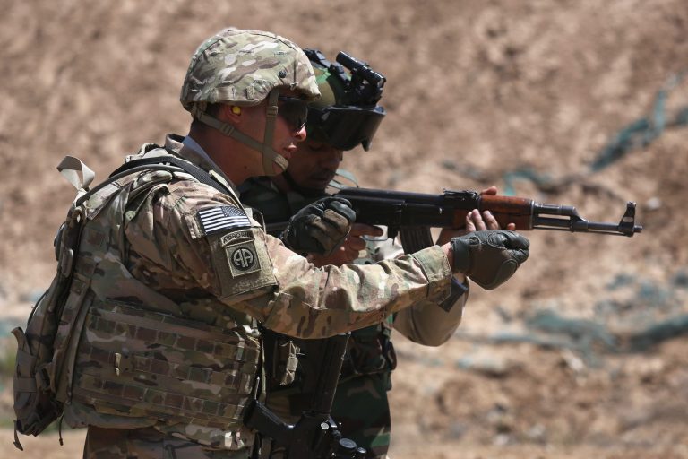 A U.S. Army trainer instructs an Iraqi Army recruit at a military base on April 12, 2015 in Taji, Iraq. (Photo by John Moore/Getty Images)