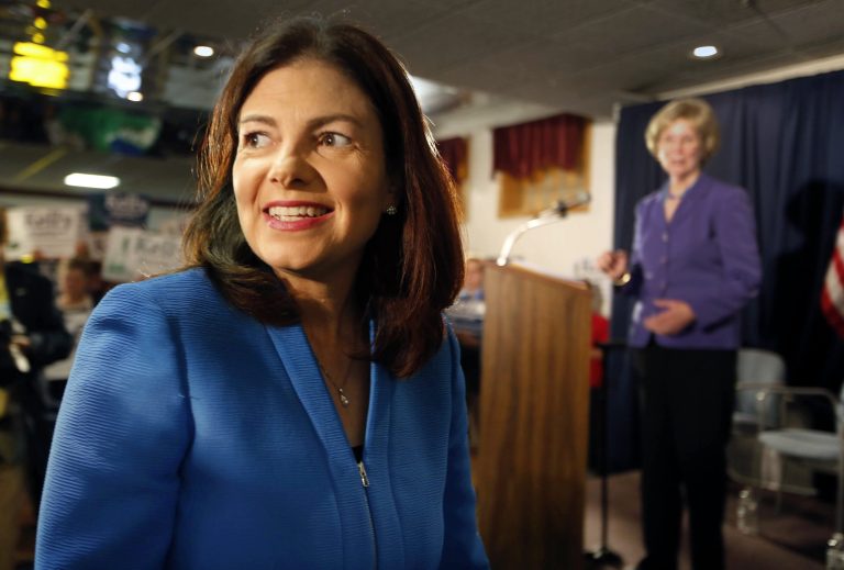 Former Speaker of the House donna Sytek, right, watches as Sen. Kelly Ayotte, R-N.H., arrives and where she announced her plans to seek a second term Tuesday, June 30, 2015, in Manchester, N.H. (AP Photo/Jim Cole)