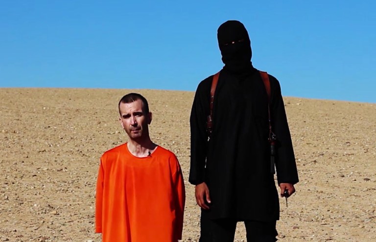 This image made from video posted on the Internet by Islamic State militants purports to show British aid worker David Haines before he was beheaded. (AP)