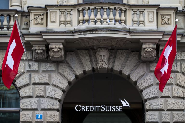 FILE - In this April 27, 2014 file picture  Swiss flags fly at the entrance of of Swiss bank Credit Suisse in Zurich, Switzerland.E uropean bank Credit Suisse AG pleaded guilty Monday May 19, 2014  to helping wealthy Americans avoid paying taxes through secret offshore accounts and agreed to pay about US $2.6 billion. The Justice Department said it was the largest penalty imposed in any criminal tax case. Credit Suisee is the largest bank to plead guilty in more than 20 years. (AP Photo/Keystone,Patrick B. Kraemer)