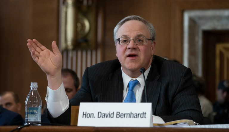 In this July 8, 2019 file photo President Donald Trump listens as Secretary of the Interior David Bernhardt speaks during an event on the environment in the East Room of the White House in Washington.