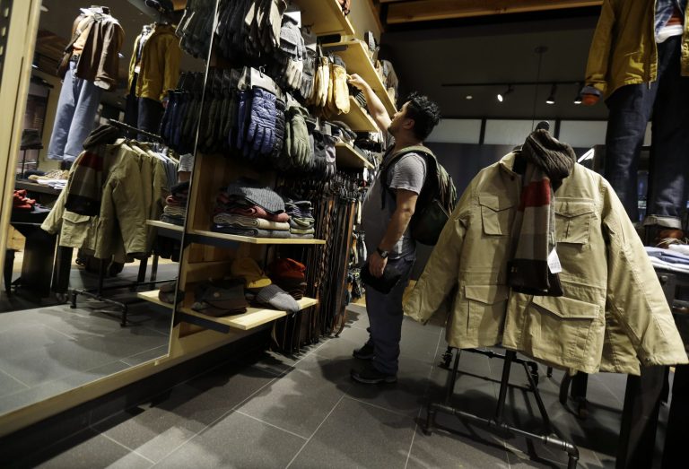 In this Friday, Oct. 4, 2013, photo, a shopper browses at a Timberland store in Skokie, Ill. The Conference Board releases the Consumer Confidence Index for October on Tuesday, Oct. 29, 2013. (AP Photo/Nam Y. Huh)