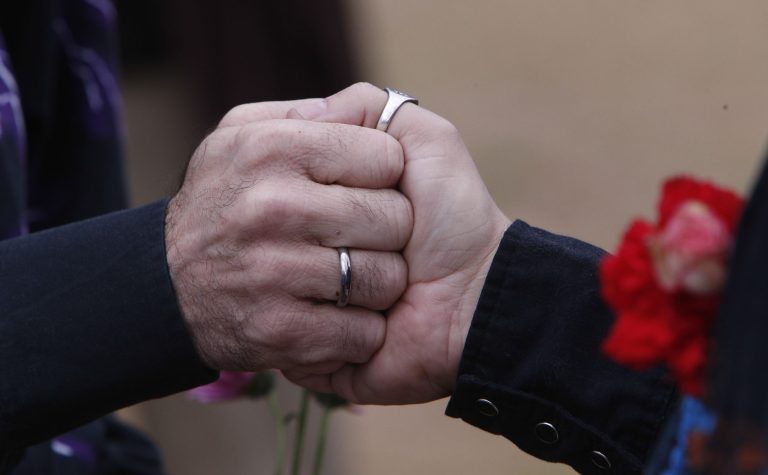 Steve Davis and James Farless hold hands as they are married in Linn Park, at the Jefferson County courthouse, Monday, Feb. 9, 2015, in Birmingham, Ala. (AP Photo)Â 