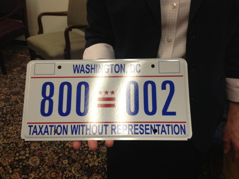 D.C. Councilwoman Mary Cheh displays the license plate that was presented to President Obama's representatives. (Photo: Alan Blinder/The Washington Examiner)