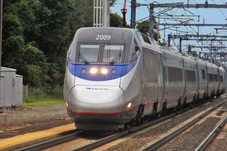 An Amtrak Acela Express runs through Old Saybrook, Conn. (Photo by Michael Kurras/Wikipedia user Shreder 9100, used under a Creative Commons license.)