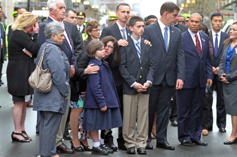 The Richard family along with Boston Mayor Marty Walsh and Massachusetts Gov. Deval Patrick participate in a wreath laying ceremony to commemorate the one year anniversary of the Boston Marathon bombings, Tuesday, April 15, 2014, in Boston. Martin Richard lost was killed in the bombing. (AP Photo/The Boston Herald, Nancy Lane) BOSTON GLOBE OUT; METRO BOSTON OUT; MAGS OUT; ONLINE OUT