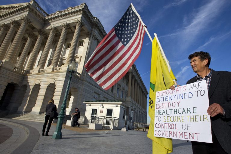 Ron Kirby, a member of the Tea Party, holds a sign against Obamacare outside the Senate side of the Capitol in Washington, Wednesday, Sept. 25, 2013, in support of Sen. Ted Cruz, R-Texas, as the senator continues his lengthy speech in opposition to President Barack Obama's health care law. The Democratic-controlled Senate is on a path toward defeating tea party attempts to dismantle President Barack Obama's health care law, despite an overnight talkathon on the chamber's floor led by Texas Sen. Ted Cruz. (AP Photo/Jacquelyn Martin)