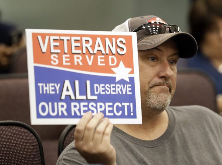 Steve Damron, 50, of Spring Hill, Fla., holds up a sign during a Hillsborough County Commission meeting about possible moving of a Confederate statue in Tampa, Fla. Damron said the President Donald Trump handled the Charlottesville, Va. situation well, and he agreed with Trump that 