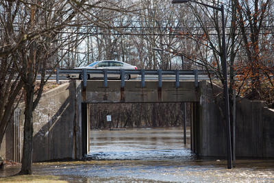 Water from the Patuxent River overflows onto a road in Laurel, Maryland. Heavy rains have swollen the Patuxent river, forcing the Washington Suburban Sanitary Commission (WSSC) to release water from the flood gates of the T. Howard Duckett Dam, Thursday, January 31st, 2013