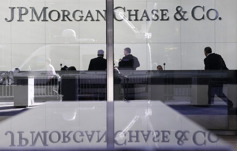   FILE - In this May 11, 2012 file photo, people stand in the lobby of JPMorgan Chase headquarters in New York. Regulators in the U.S. and U.K said Thursday, Sept. 19. 2013 that the largest U.S. bank's weak oversight of its London operation allowed traders there to assign inflated values to transactions and cover up huge losses as they ballooned. JPMorgan Chase & Co. will pay $920 million and has admitted that it failed to watch over trading that led to a $6 billion loss and renewed worries about serious risk-taking by major banks. (AP Photo/Mark Lennihan, File)  