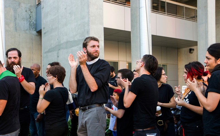 Rev. Joe Stapleton, of Cornerstone Community Church, waits in line outside the Durham County Jail where many 