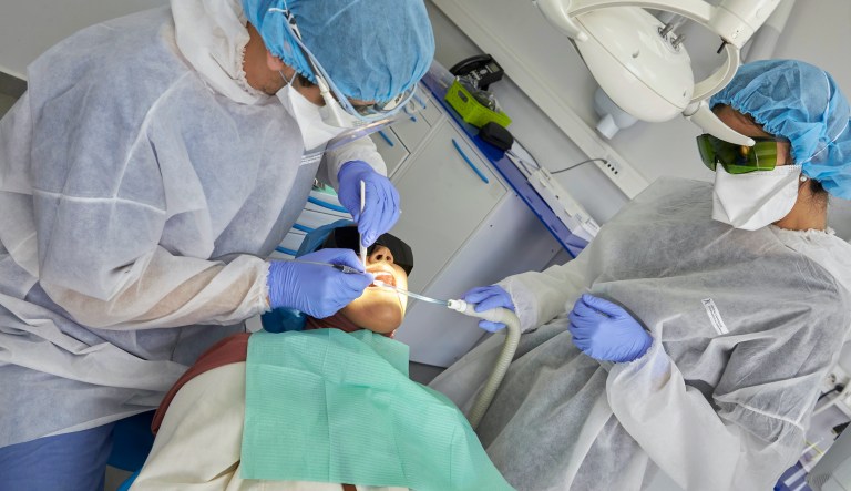 Dentist Dr. Afif, left, and his assistant wear protective suits and masks to avoid contamination with the COVID-19 virus at the Cheikh Hopital de Khalifa in Casablanca, Morocco, Thursday June 11, 2020. Despite the extension of the state of emergency for health until July 10 in Morocco, a series of measures to alleviate containment have been put in place.