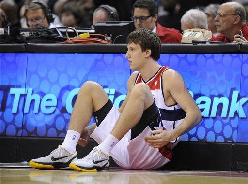 Washington Wizards forward Jan Vesely, of the Czech Republic, looks on as he leans against the scorer's table during the first half of an NBA preseason basketball game against the Philadelphia 76ers, Friday, Dec. 16, 2011, in Washington. (AP Photo/Nick Wass)