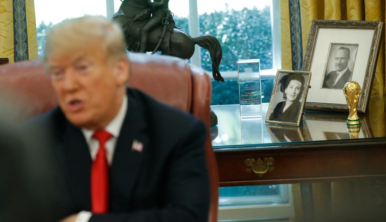 Portraits of President Donald Trump's parents Mary Anne MacLeod Trump and Fred Trump, far right, are seen in the Oval Office of the White House in Washington, during Trump's meeting to discuss potential damage from Hurricane Michael, Wednesday, Oct. 10, 2018.