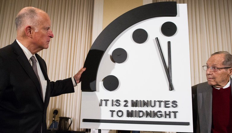 Former California Gov. Jerry Brown, left, and former Secretary of Defense William Perry unveil the Doomsday Clock during The Bulletin of the Atomic Scientists news conference in Washington, Thursday, Jan. 24, 2019.  The Doomsday Clock is set at two minutes to Midnight.