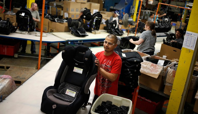 Noe Castaneda assembles child car seats at the Dorel Juvenile Group factory in Columbus, Indiana, U.S. on Tuesday, March 25, 2014. The U.S. Census is scheduled to release their next durable goods report on Wednesday, March 26.