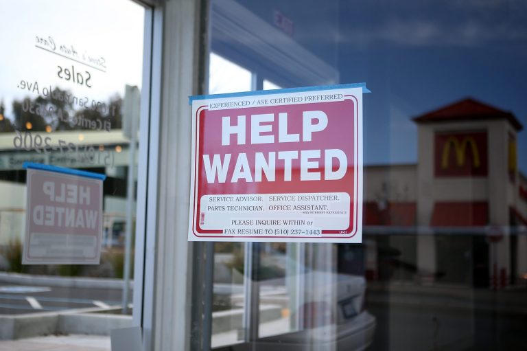 A 'Help Wanted' sign is posted in the window of an automotive service shop on March 8, 2013, in El Cerrito, California.